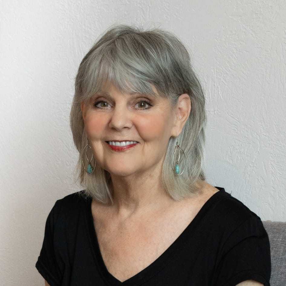 Portrait of Lois, a professional stylist at Above All Grand Salon & Spa, showcasing their expertise and style.