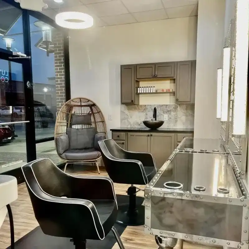 Modern salon interior with stylish chairs, unique lighting, and a cozy waiting area.