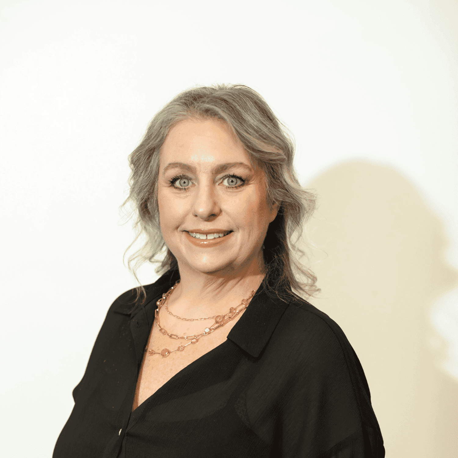 Portrait of Amber Storrs, a professional stylist at Brown & DeLine Salon, showcasing their expertise and style.