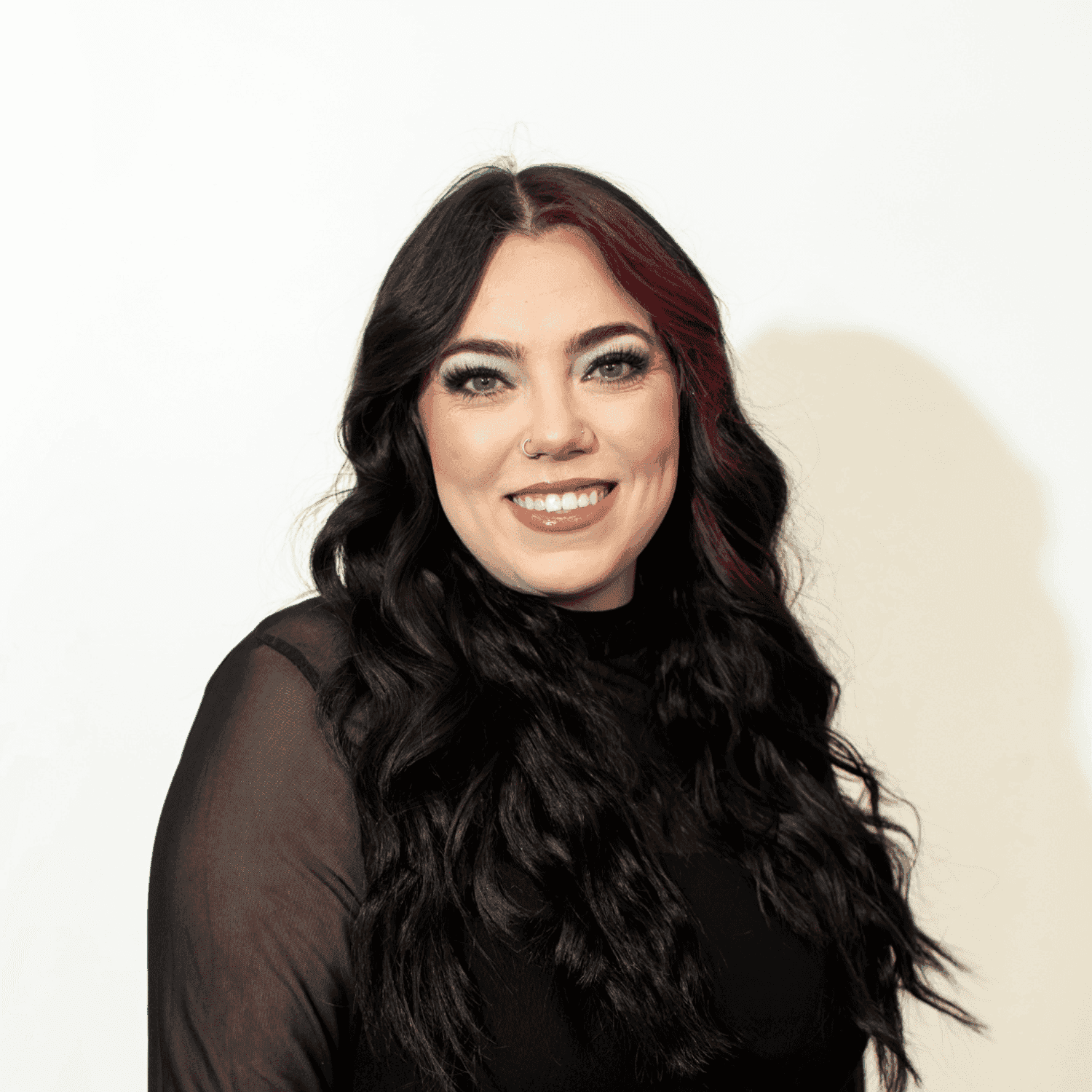 Portrait of Mackenzie Schoelles, a professional stylist at Brown & DeLine Salon, showcasing their expertise and style.