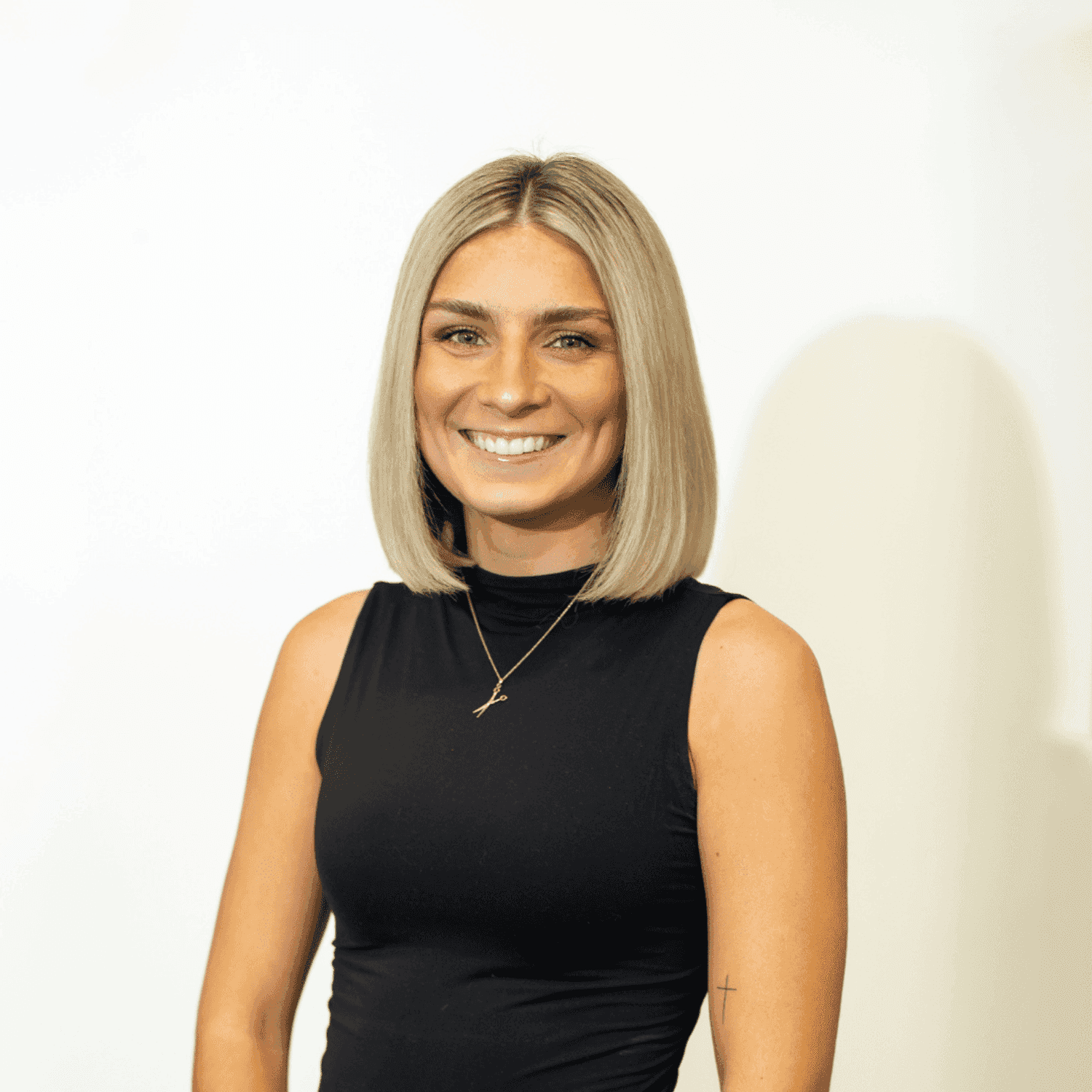 Portrait of Calista Issel, a professional stylist at Brown & DeLine Salon, showcasing their expertise and style.