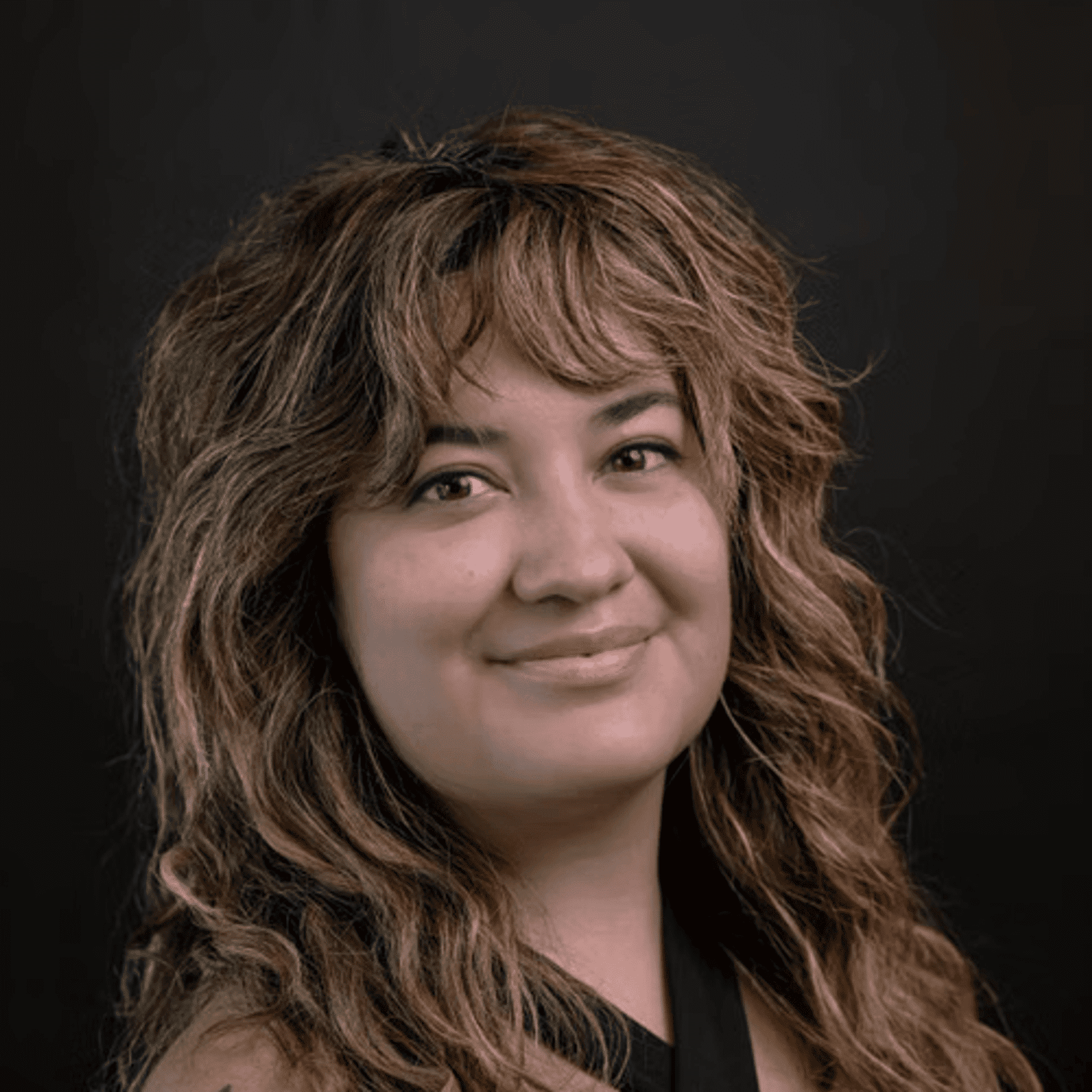 Portrait of Brittany, a professional stylist at Chad + Co., showcasing their expertise and style.