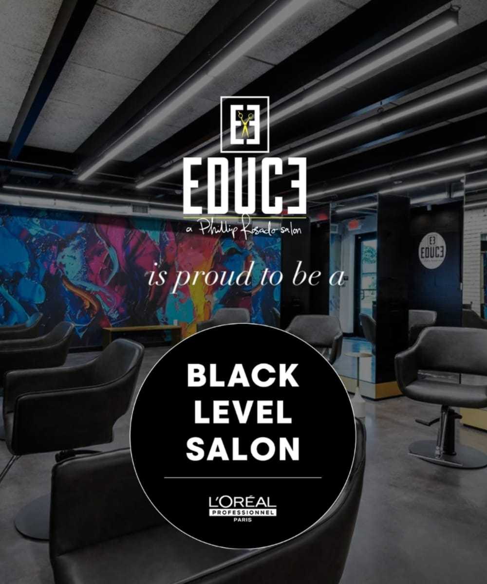 Salon interior with chairs and colorful wall art; recognized as a Black Level Salon by L'Oréal.