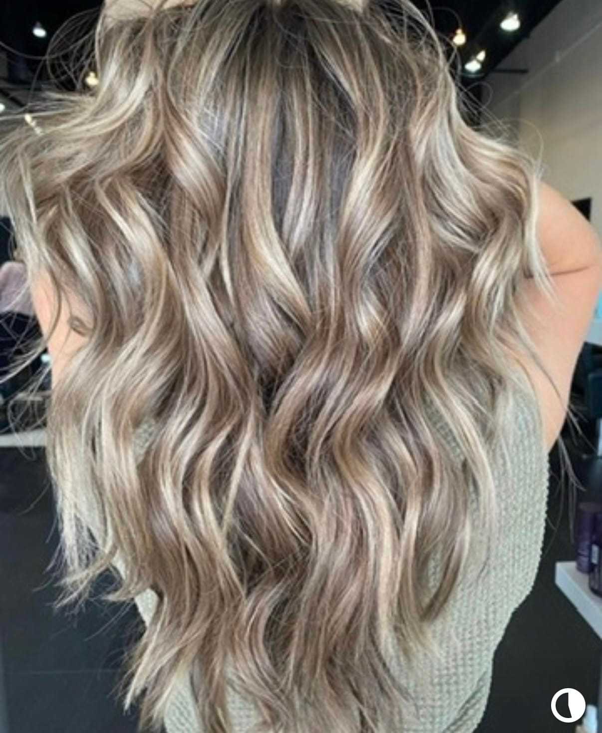 Wavy blonde hair with highlights styled in loose curls, viewed from the back.