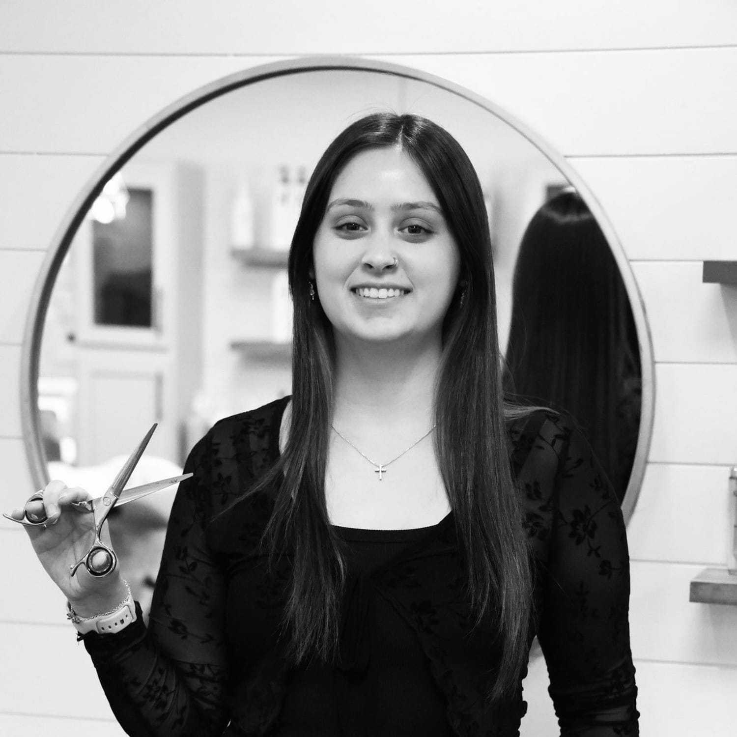 Portrait of Kaitlyn, a professional stylist at Indigo, showcasing their expertise and style.