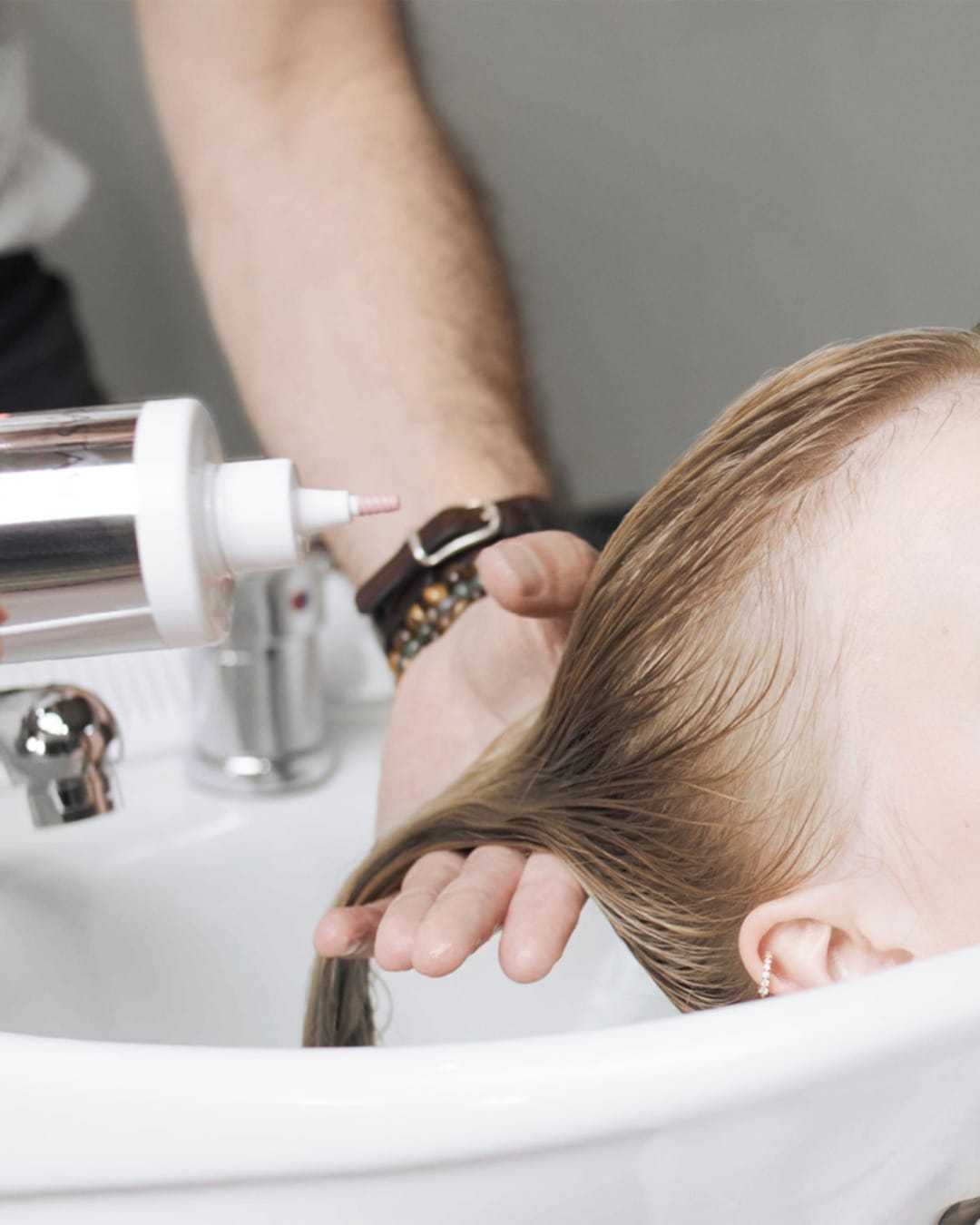 Washing hair in a salon sink with gentle care.