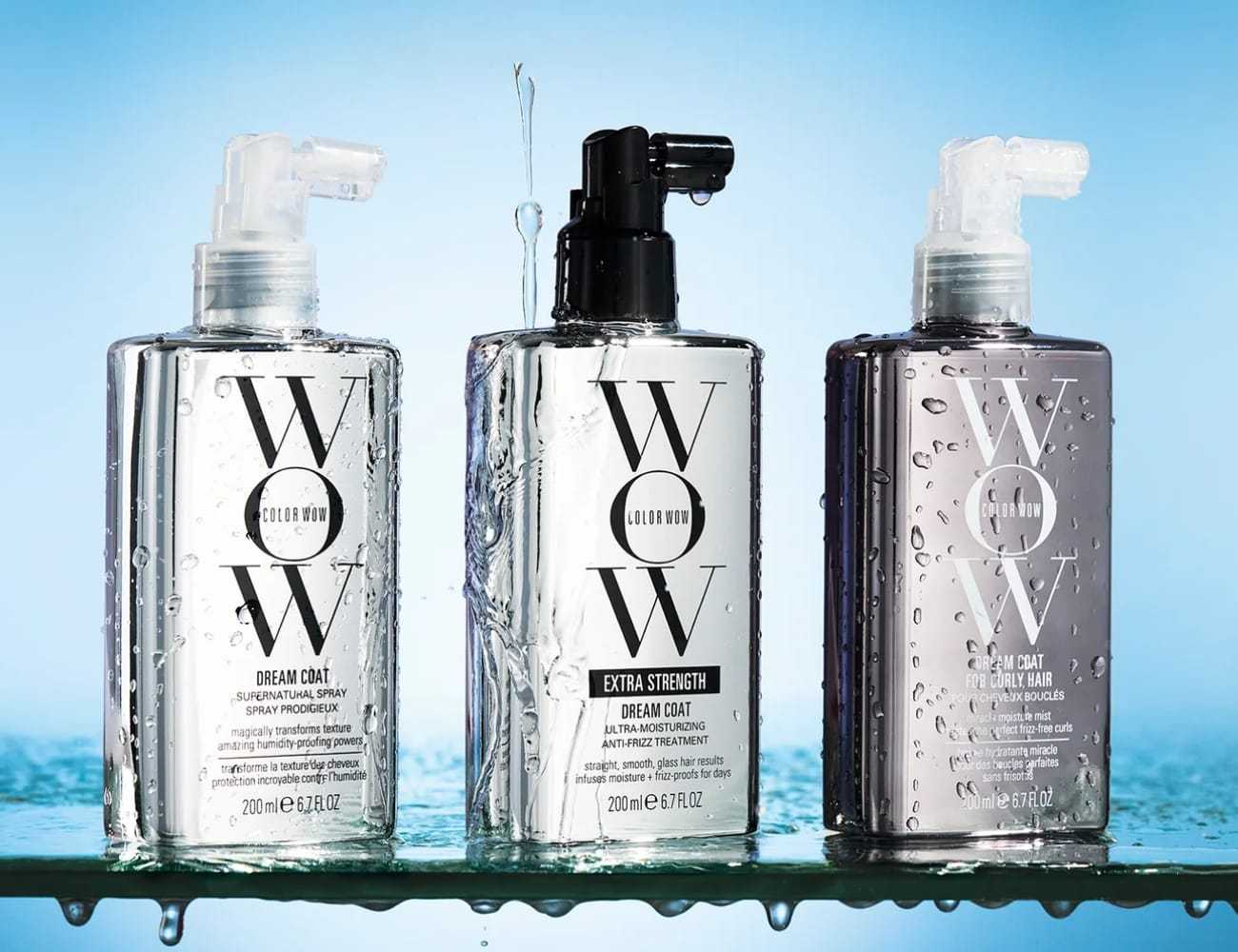 Color Wow hair care bottles with spray tops against a water backdrop.