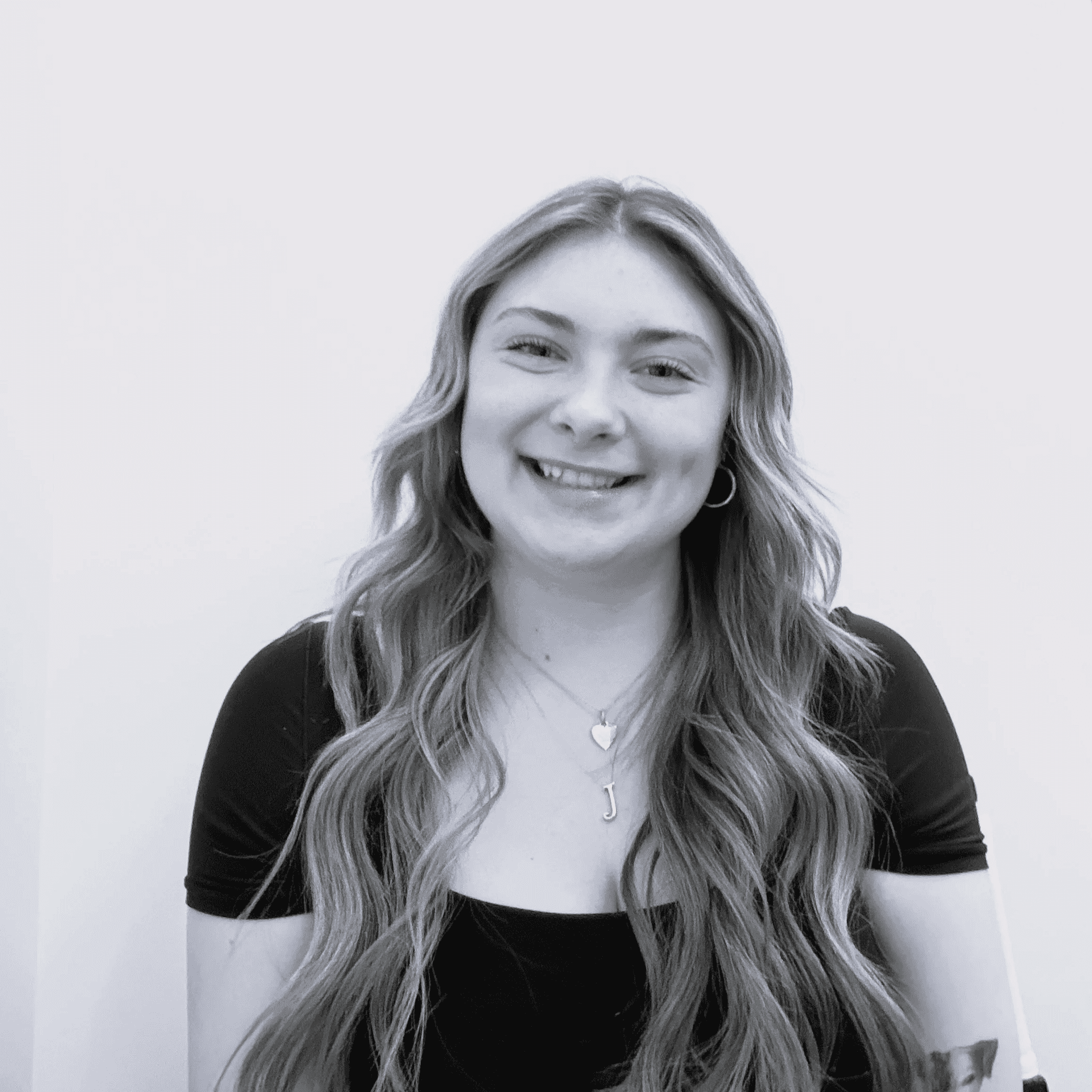 Portrait of Josie, a professional stylist at Jungle Red Salon, showcasing their expertise and style.