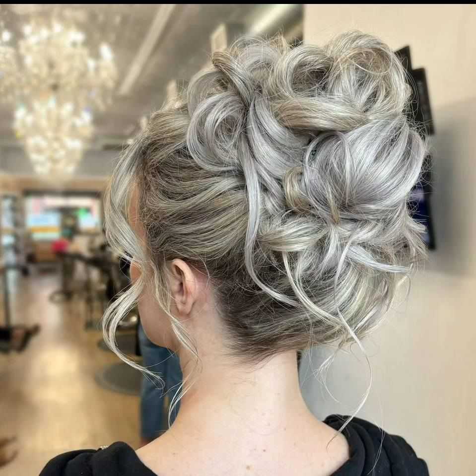 Elegant updo with curls in a salon setting.