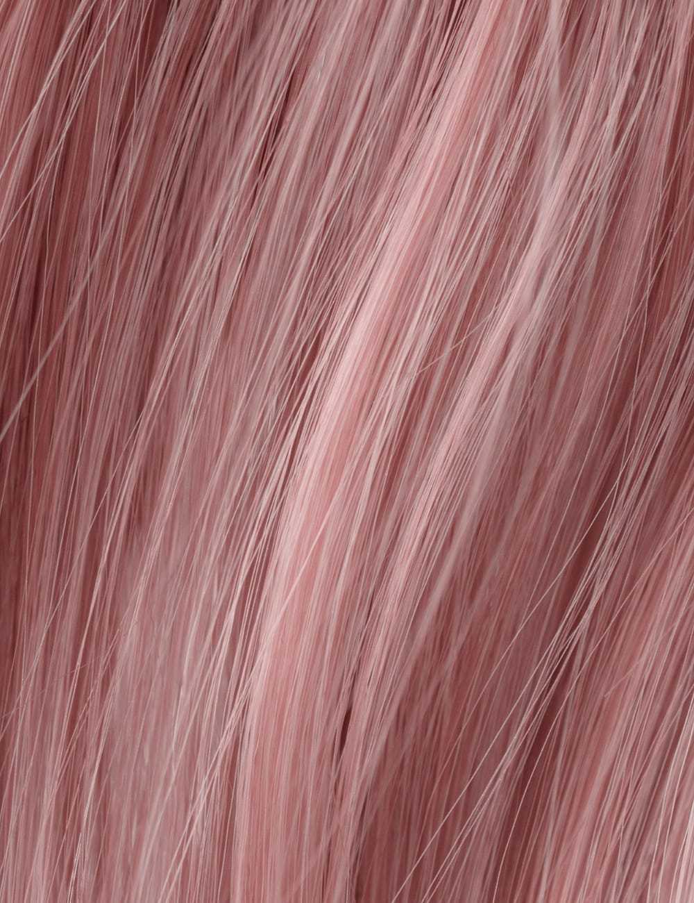 Pink hair texture close-up with soft, flowing strands.