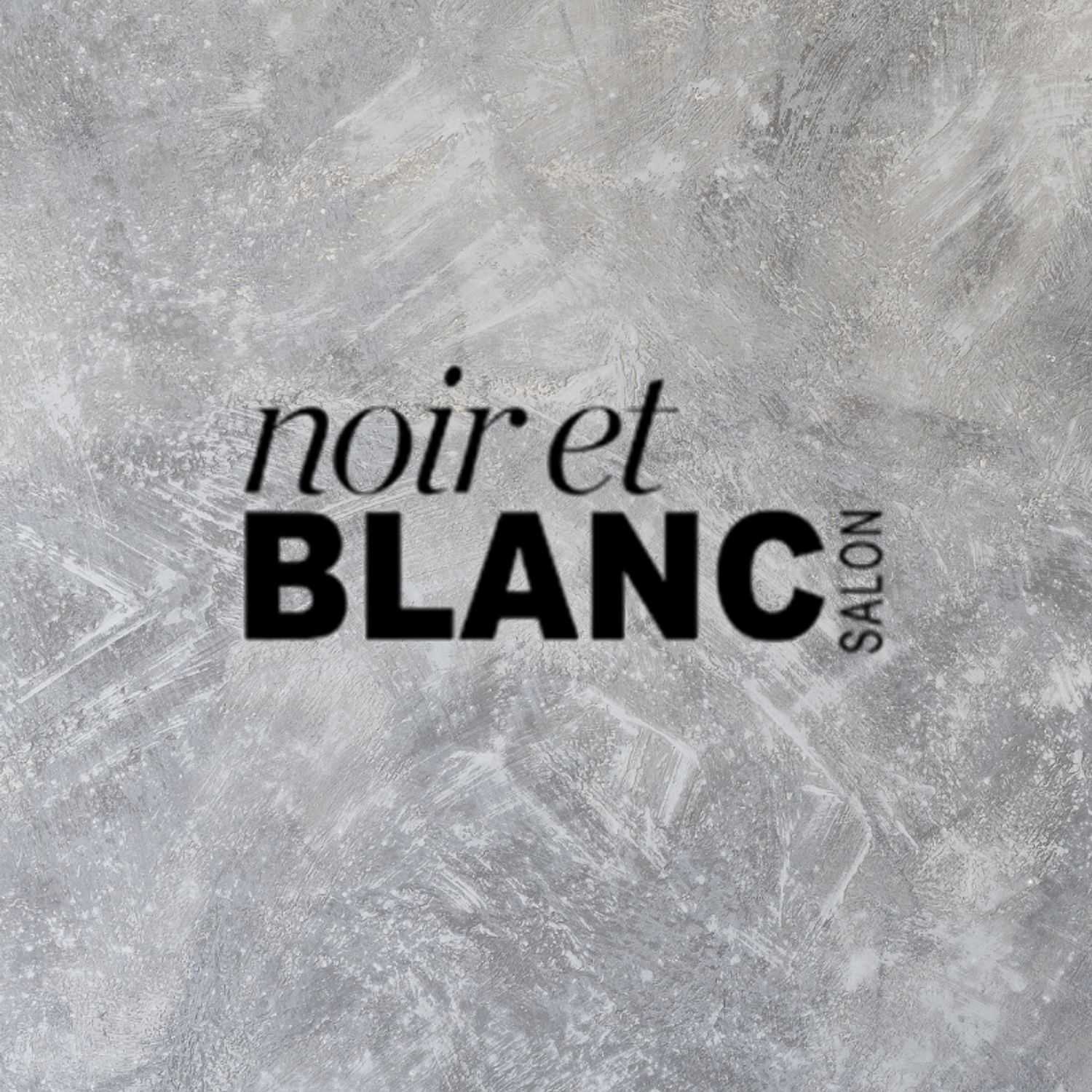 Portrait of Aziza, a professional stylist at Noir et Blanc Salon, showcasing their expertise and style.