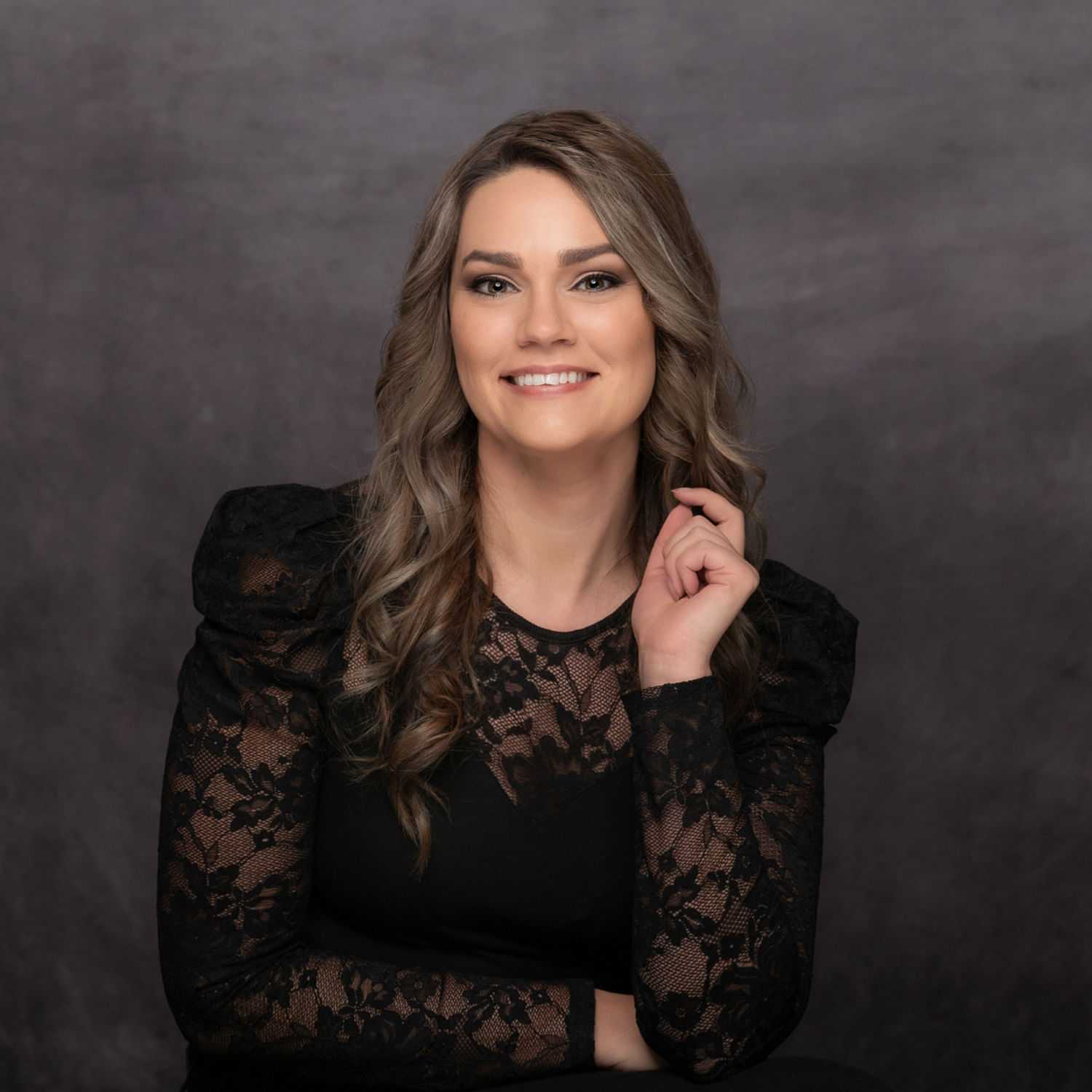 Portrait of Weslie Cheney, a professional stylist at Revive Hair Salon & Day Spa, showcasing their expertise and style.