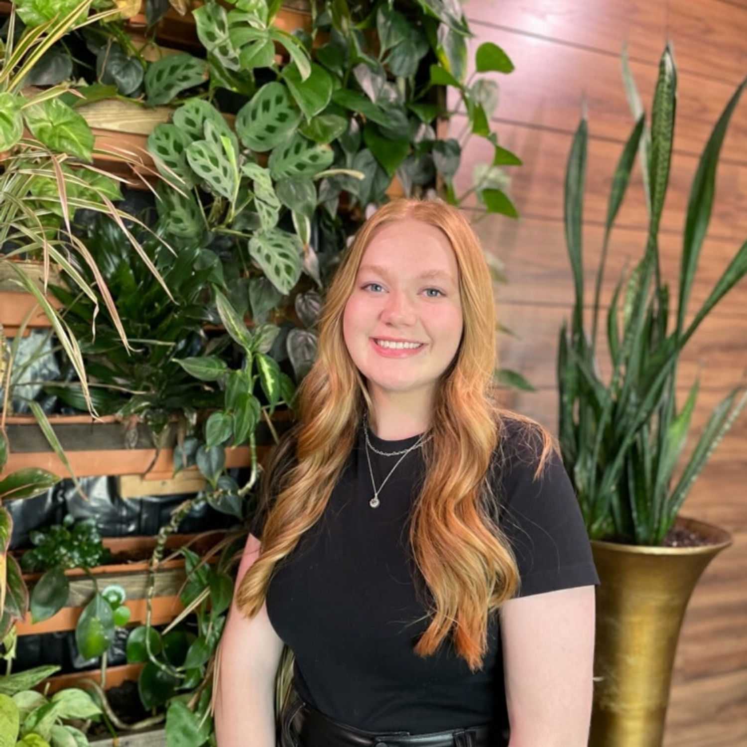 Portrait of Emma Wertz, a professional stylist at Revive Hair Salon & Day Spa, showcasing their expertise and style.