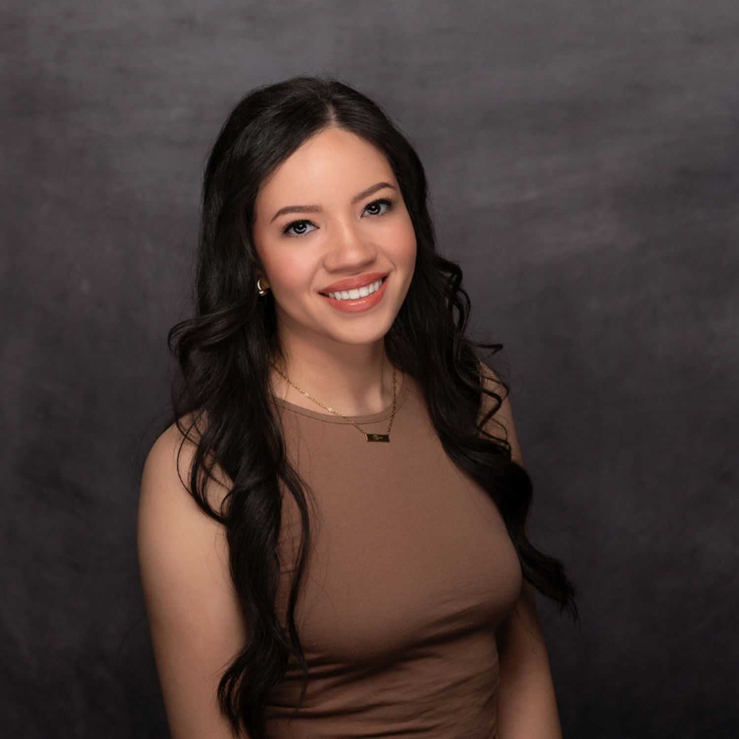 Portrait of Kendy Viera, a professional stylist at Revive Hair Salon & Day Spa, showcasing their expertise and style.