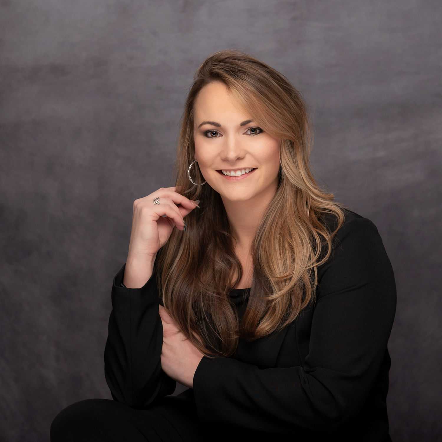 Portrait of Ashley Boehler, a professional stylist at Revive Hair Salon & Day Spa, showcasing their expertise and style.