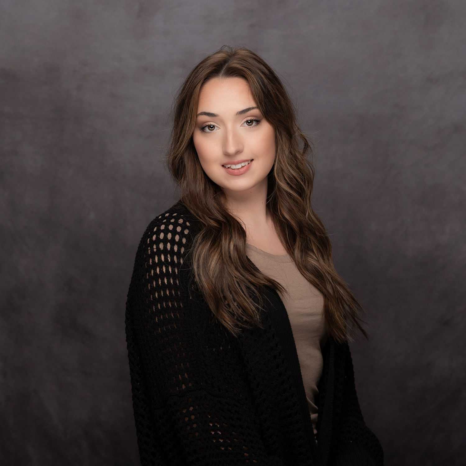 Portrait of Michaela Thompson, a professional stylist at Revive Hair Salon & Day Spa, showcasing their expertise and style.