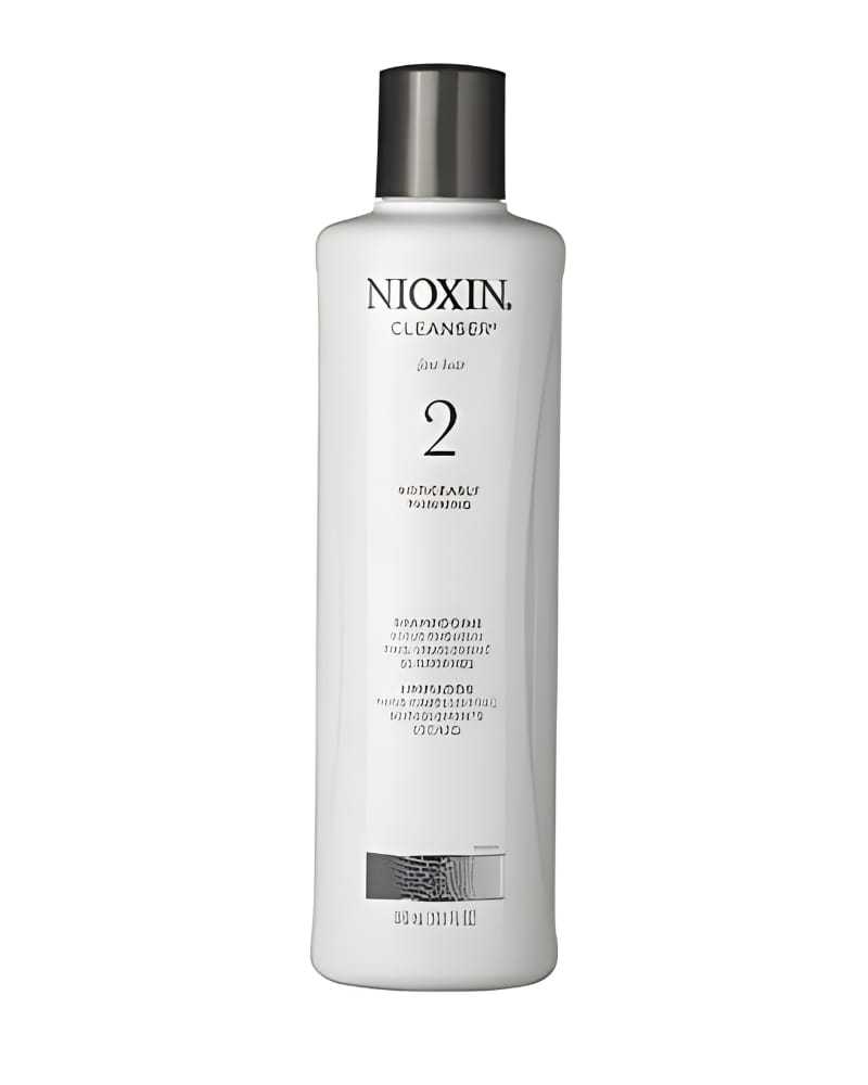 Nioxin Cleanser shampoo bottle, labeled for thinning hair, stands against a white background.