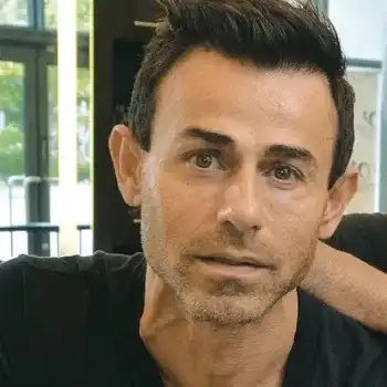 Portrait of Al Shamas, a professional stylist at Salon Dolce Vita, showcasing their expertise and style.