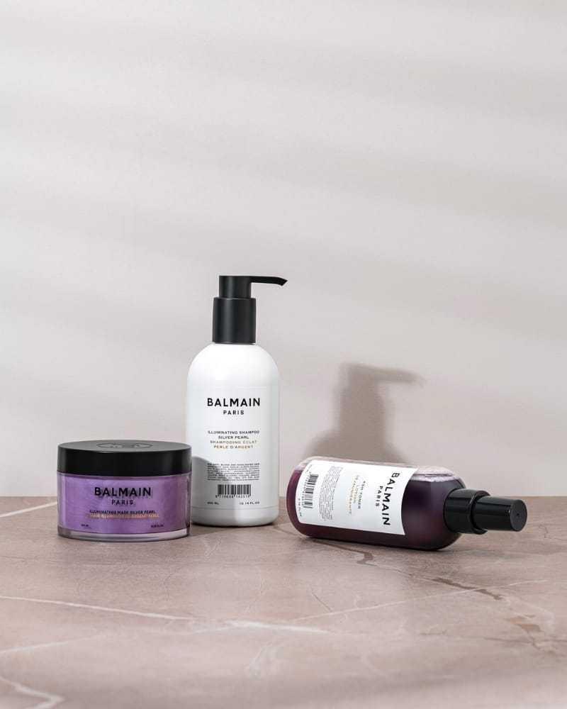 Balmain Paris hair care products on a marble surface.