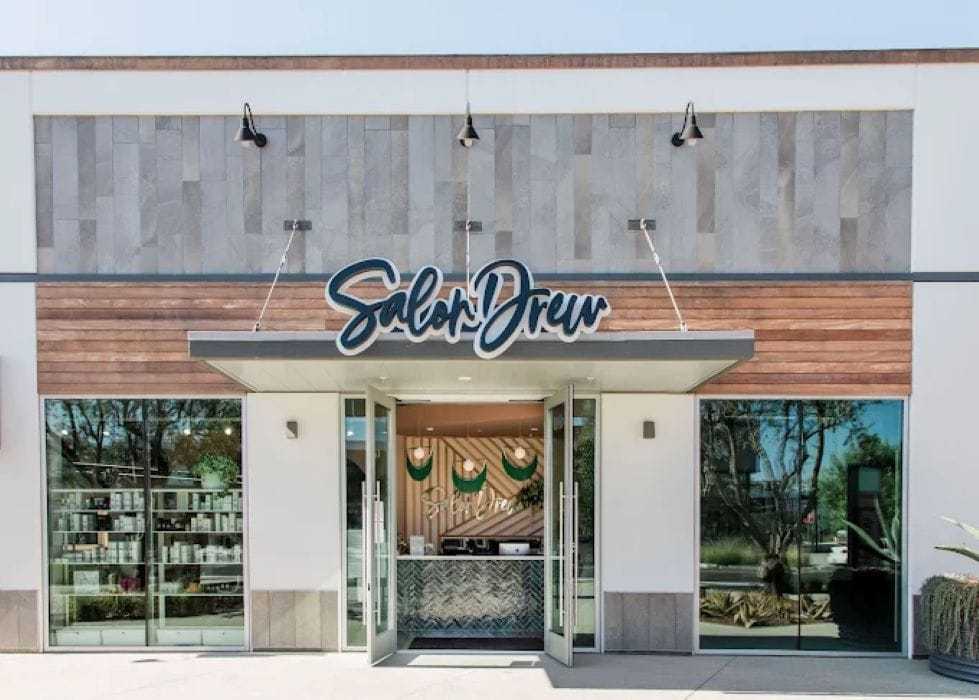 Exterior of Salon Drew with large glass windows and modern signage.