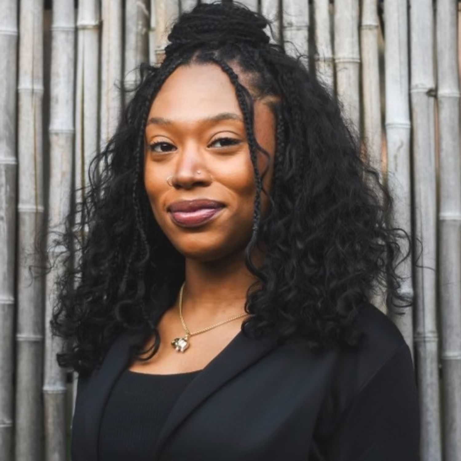 Portrait of Adriana, a professional stylist at [salon] 718, showcasing their expertise and style.