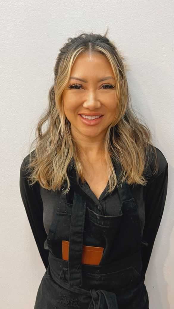 Portrait of Sachi, a professional stylist at [salon] 718, showcasing their expertise and style.
