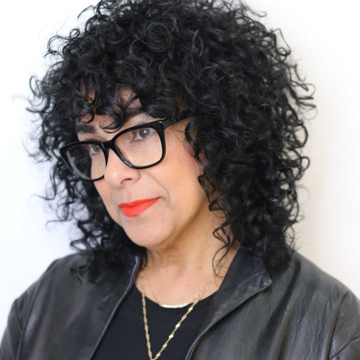 Portrait of Cynthia, a professional stylist at [salon] 718, showcasing their expertise and style.