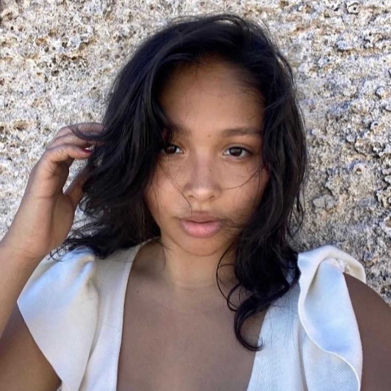 Portrait of Nalani, a professional stylist at [salon] 718, showcasing their expertise and style.