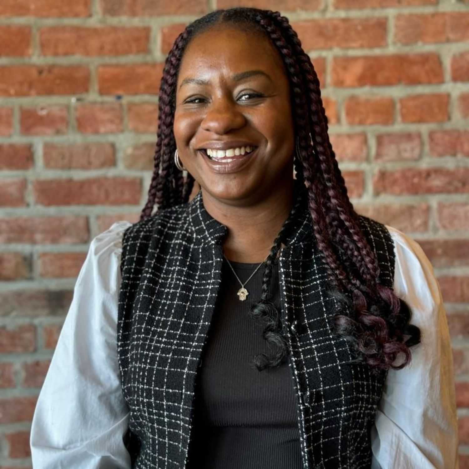 Portrait of Tayo, a professional stylist at [salon] 718, showcasing their expertise and style.