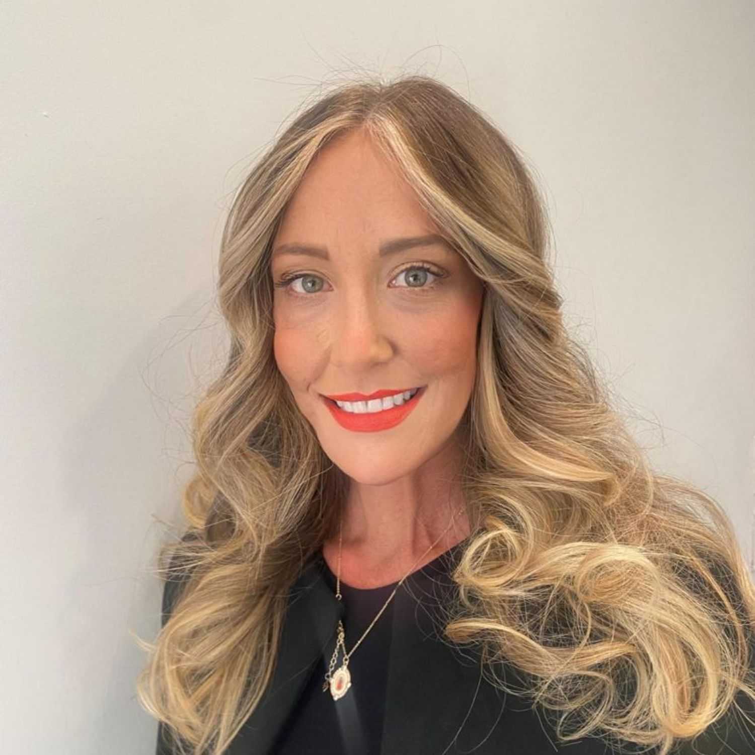 Portrait of Corinne, a professional stylist at [salon] 718, showcasing their expertise and style.