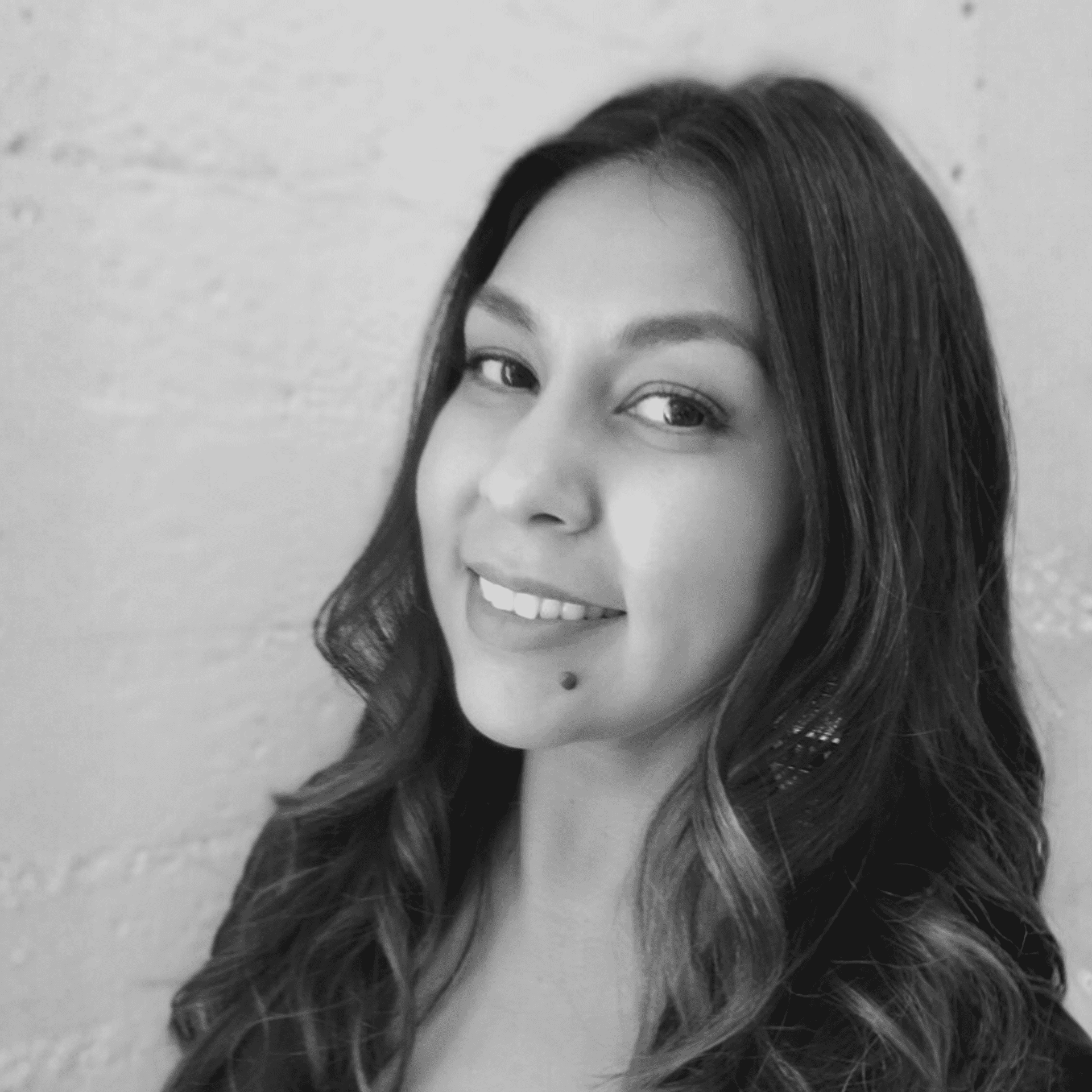 Portrait of Tannia Flory, a professional stylist at Salon Savoir, showcasing their expertise and style.