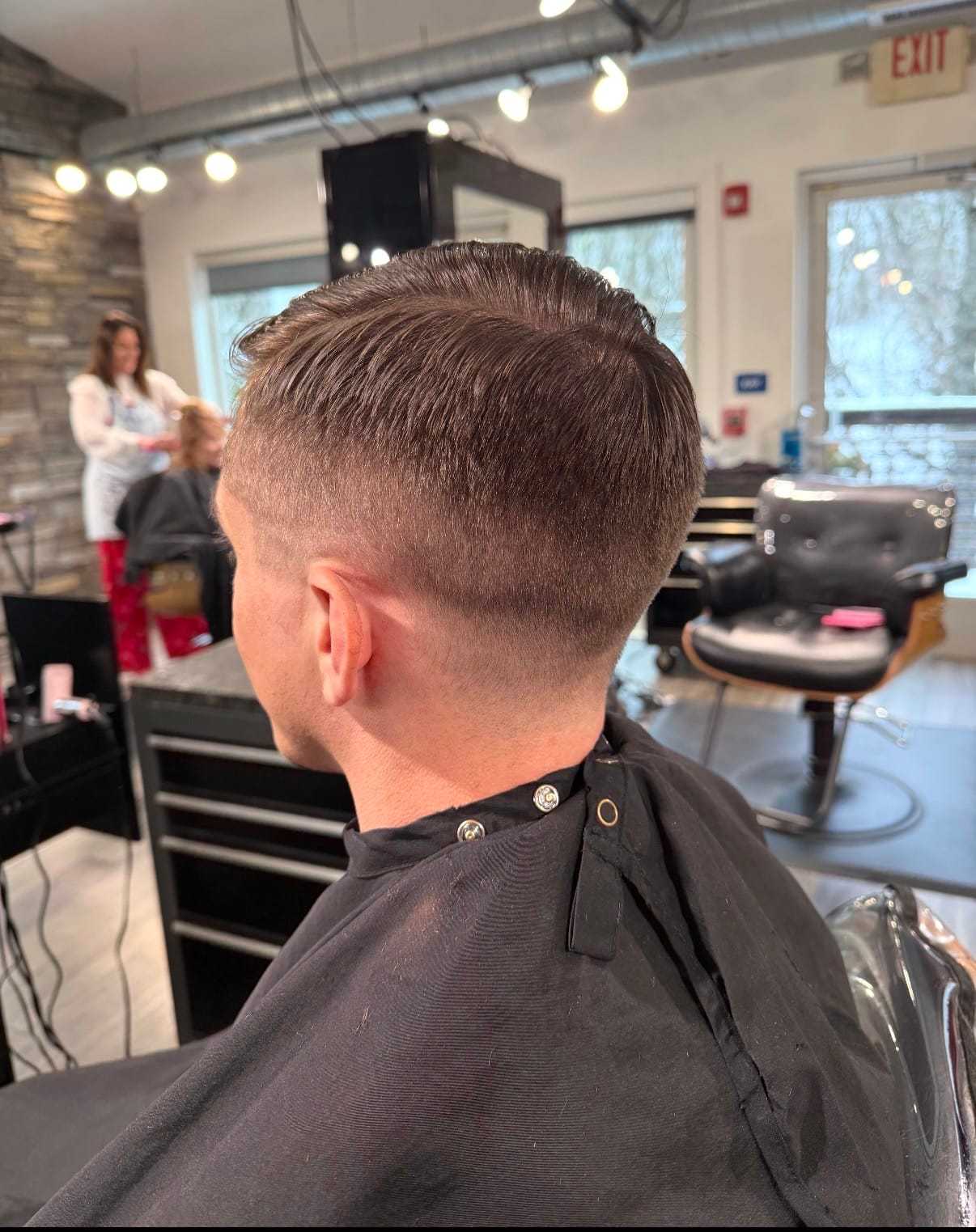 Man with a fresh fade haircut in a modern hair salon.