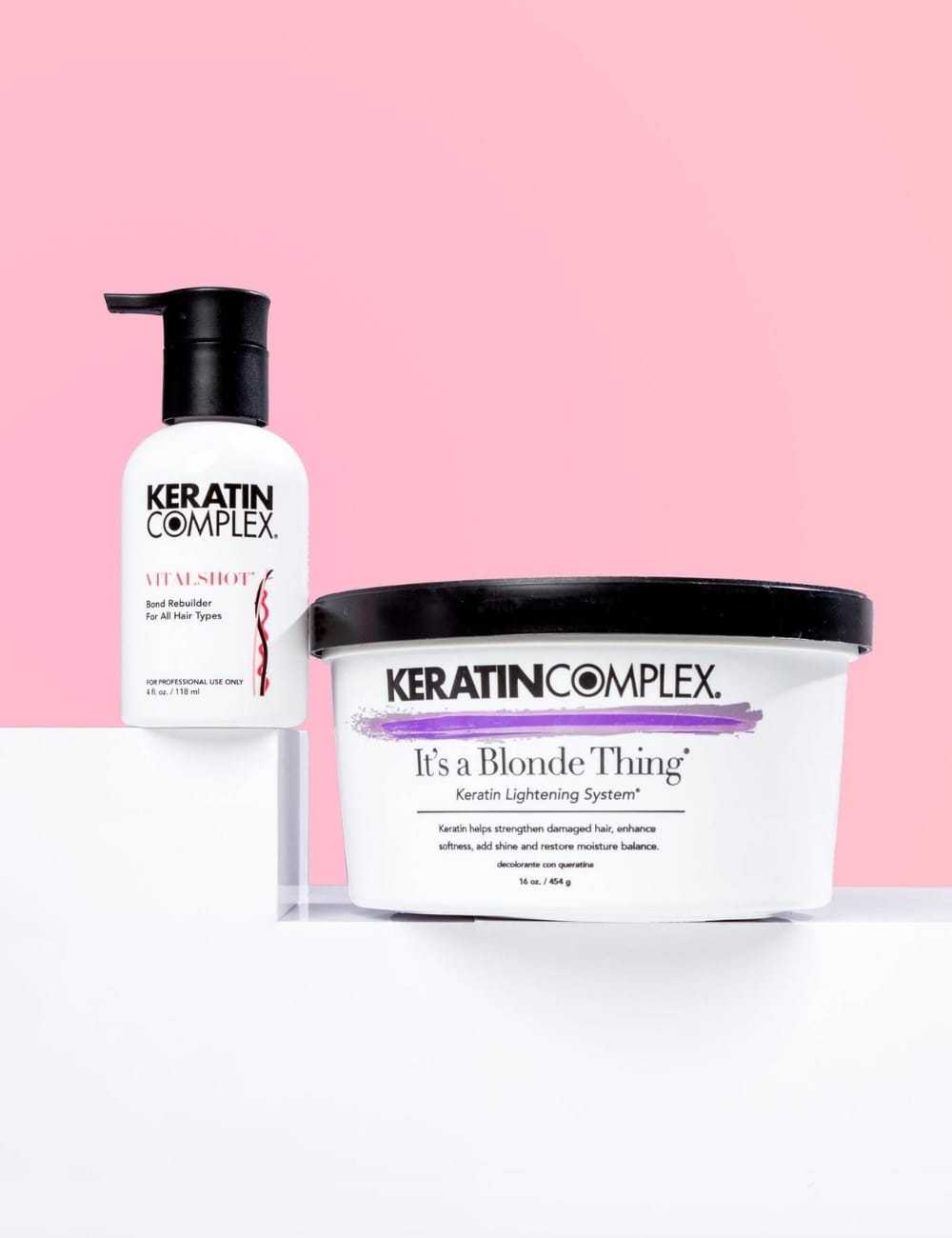 Keratin Complex haircare products on a pink and white background.