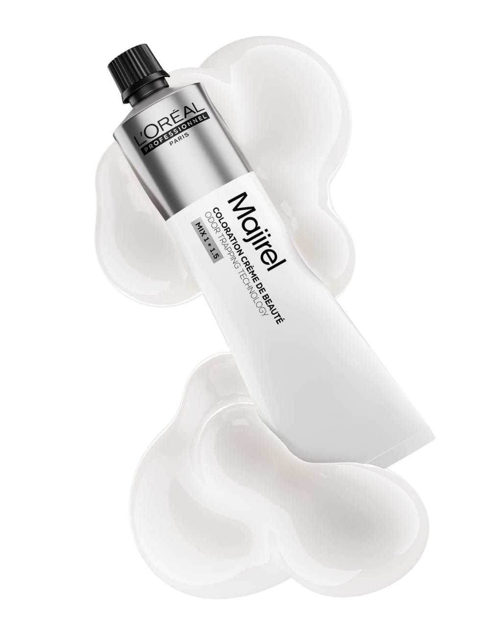 Tube of L'Oréal Majirel hair color laying on creamy white swirls.