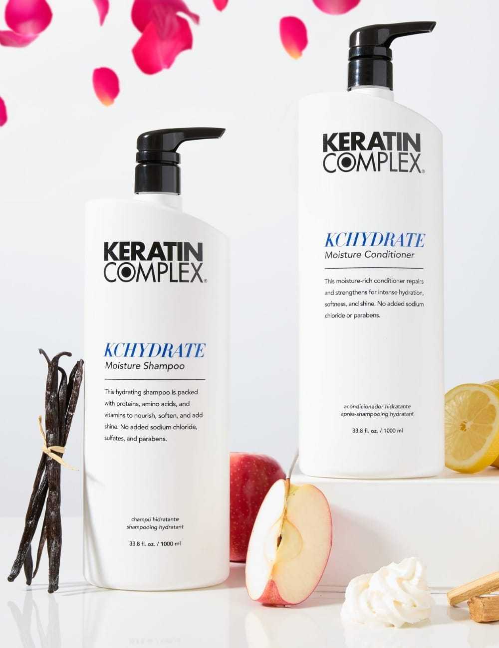 Keratin Complex shampoo and conditioner bottles with apples, lemons, and vanilla pods.